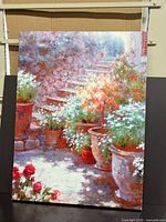 Full view of unframed oil painting showing floral garden scene
