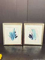 Front view of both framed abstract artworks showing designs, frames and overall condition