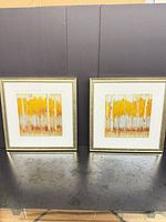 Both framed prints standing side by side