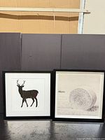 Both framed artworks side by side showing deer silhouette and hay bale print with black frames and white mats