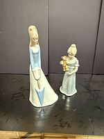 Both figurines front view showing size difference and features