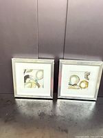 Pair of framed abstract prints side by side