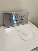 Front view of mirror acrylic sign with USB cable visible