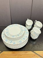 Stack of dinner and side plates with cups
