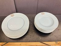 Stacks of 6 flat plates and 6 rimmed bowls on table