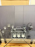 Group shot of all four metal candle holders showing relative sizes and finishes