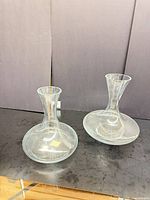 Front view of both clear glass decanters showing shape and condition