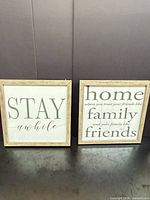 Both square wood-framed wall signs side by side