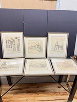 All five framed drawings displayed together