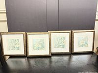 Front view showing all four framed prints aligned