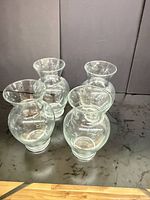 Top view showing all four clear glass hurricane vases grouped together