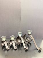 All four wrought iron scroll candle holders with glass cups and tea lights