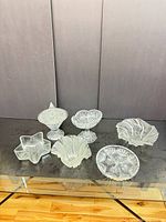 All six clear pressed glass dishes displayed together