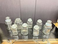 All eight clear glass canisters with lids displayed