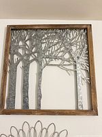 Front view showing entire square wood frame and cut metal tree design