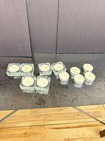 Group of 6 glass holders and 5 tealights on table