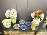 Group shot of both vases, pitcher with flowers, coasters and cork jar