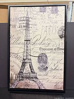 Front view showing entire framed Eiffel Tower print with black wood frame