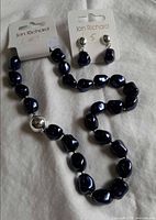 Necklace and earrings on original cards
