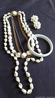 Full view of necklace, earrings and bangle
