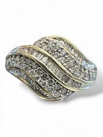 Close view of ring face showing wave design with round and baguette diamonds