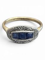 Top view showing three square sapphires set in platinum halo on yellow gold band