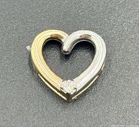 Front view of pendant showing two-tone heart and diamond accent