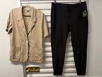 Full view of blazer and pants hung side by side