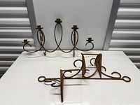5-arm gold wrought iron wall sconce and separate matching bracket on table