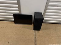 Front view of Lenovo monitor and LG subwoofer