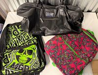 Overall view showing three bags: Lifetime duffel, Madd Gear backpack, quilted butterfly bag