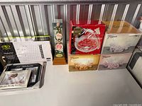 Boxed volleyball net, musical rose display, Mikasa basket, Flora bowls, picture frames grouped on shelf