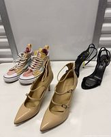 All three pairs laid out: nude heels, pastel sneakers, black sandals