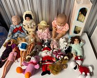 Full lot showing all dolls and plush on tabletop