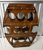 Front view showing ten bottle openings and brass rivets