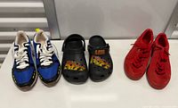 Three pairs of shoes side by side on tabletop