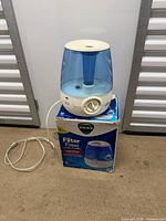 Humidifier on top of box with power cord visible