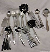 All 39 pieces of flatware and serving utensils laid out
