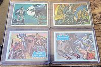 Front view of four 1966 Batman trading cards in toploaders