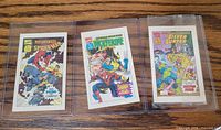 Three mini Marvel comics in sleeves showing covers of Jubilee & Spider-Man, Spider-Man & Wolverine, Silver Surfer
