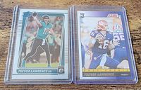Both rookie cards side by side in sleeves