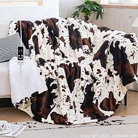 Cow print heated blanket draped on sofa