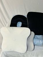 Group of six assorted memory-foam cushions stacked