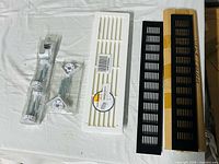 Overall lot showing two grilles and two hardware packs
