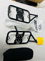 Overall view of both rack frames, seat, hardware in wrap and instruction sheet