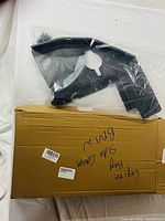 Side cover in plastic bag atop labeled box