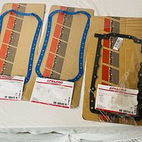 Three Fel-Pro gasket sets, two blue OS 30542 R and one black OS 30708 R