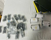Label rolls, wire clips in bags, hanging file folders on table