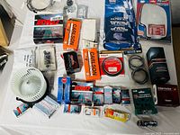 Overall view of all boxed and bagged automotive parts on table