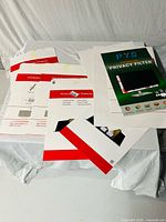 Group of PYS privacy filter packages and loose inserts on table